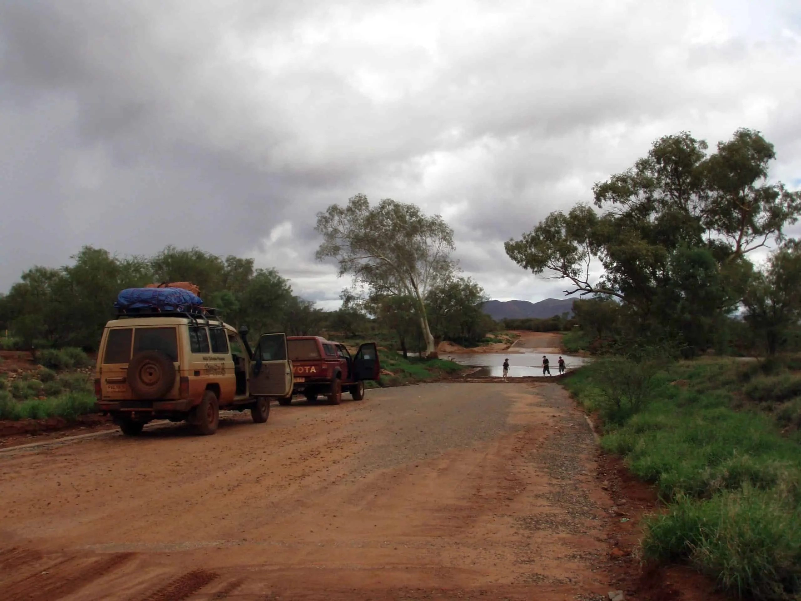 convoy Cars pulled up at water flooding across road